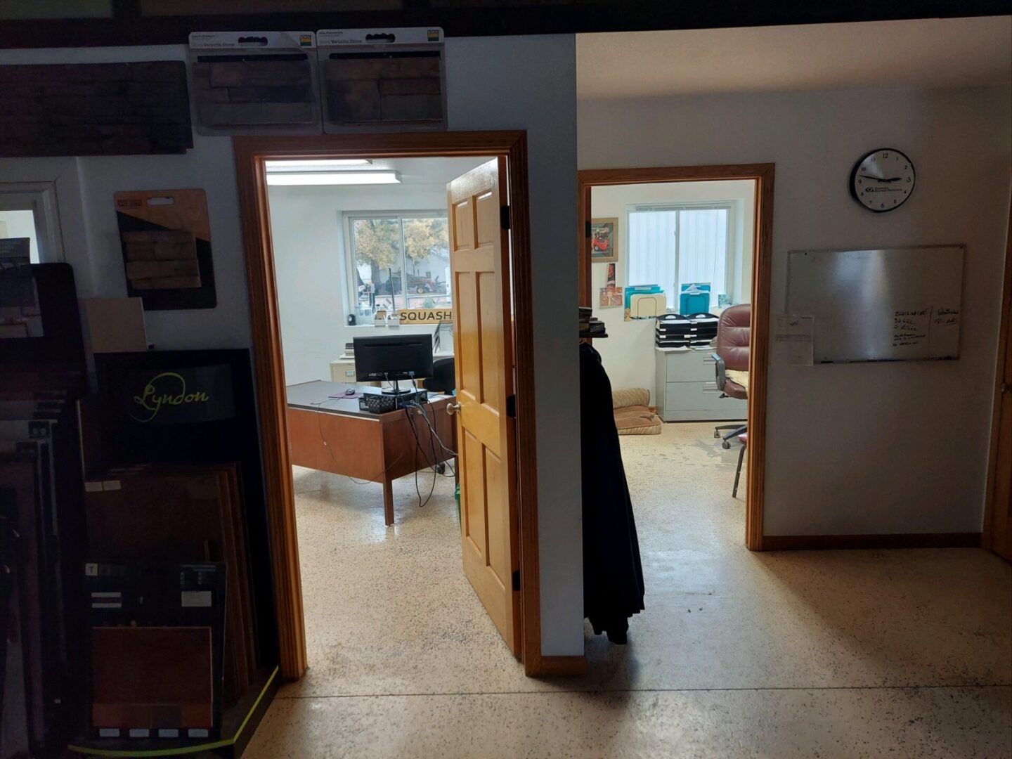 A person standing in the doorway of an office.