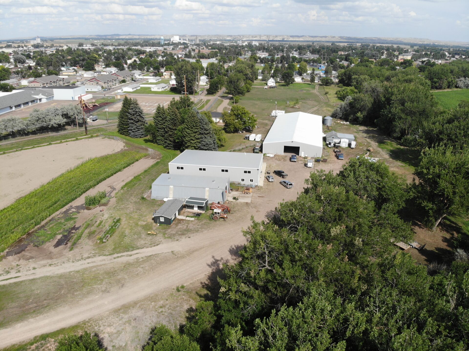 An aerial view of a farm with buildings and trees.