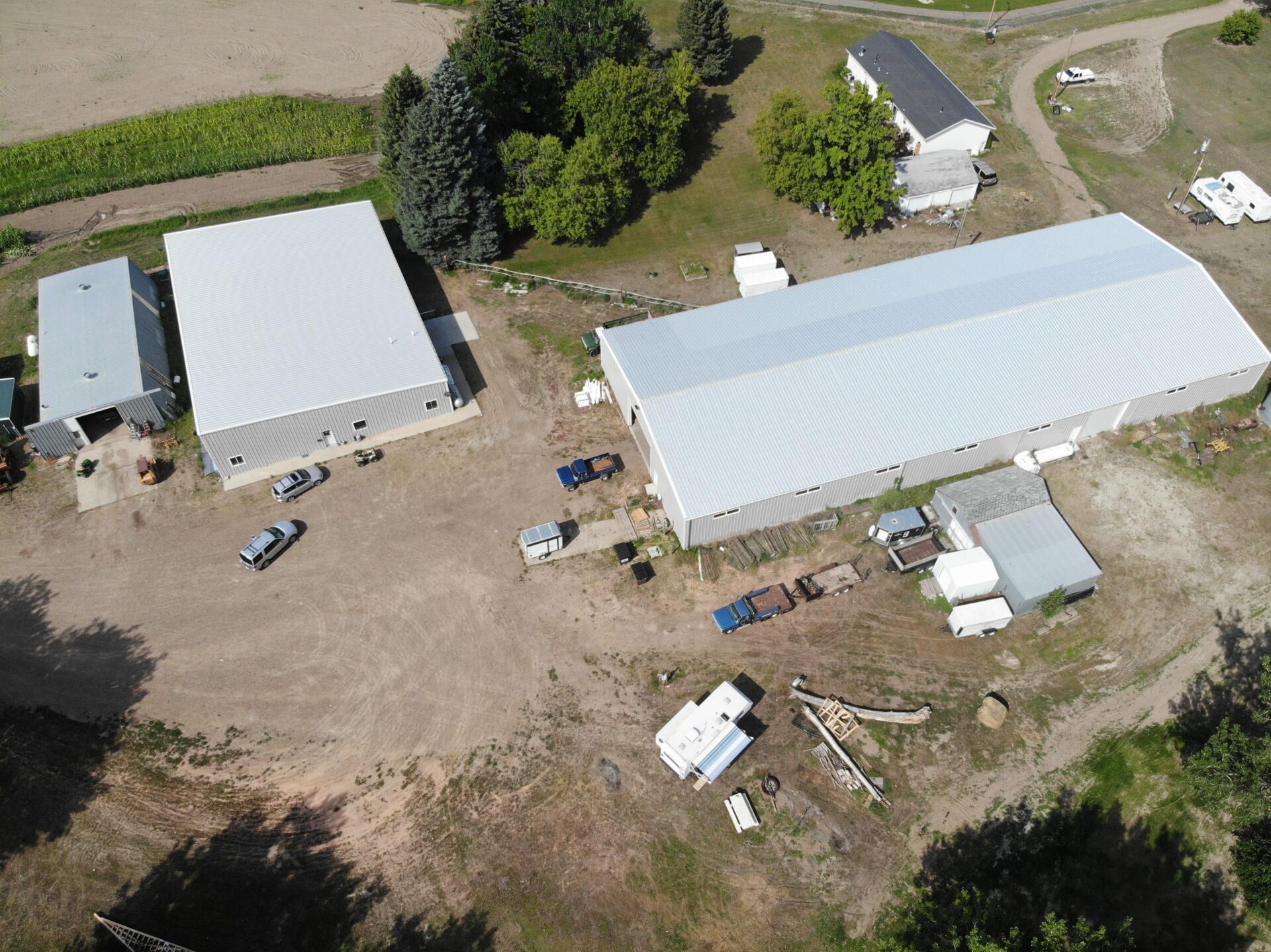 A bird 's eye view of two buildings and some trees.