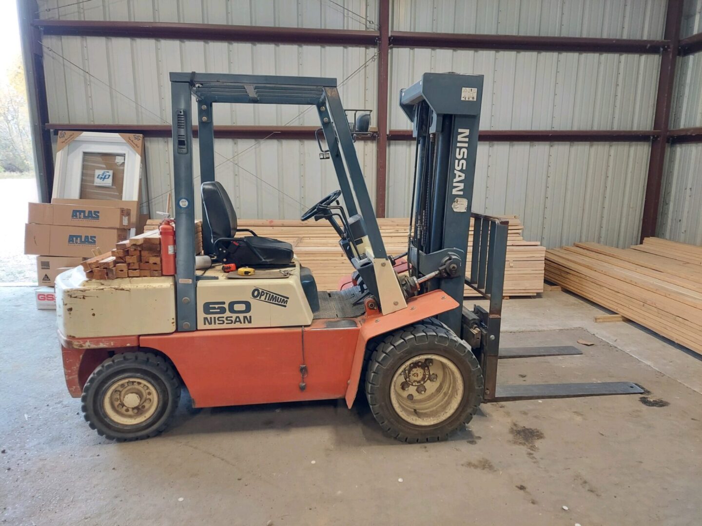 A large forklift is parked in the warehouse.